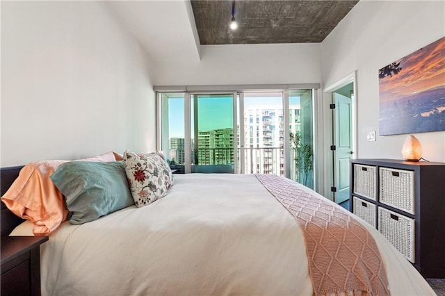 bedroom featuring a city view and access to exterior