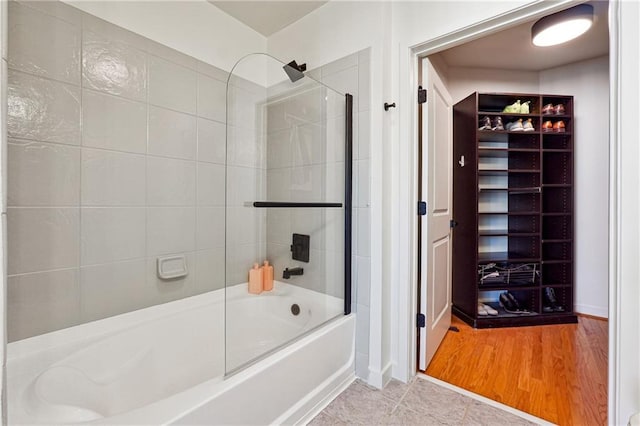 bathroom featuring tile patterned flooring and shower / bathtub combination