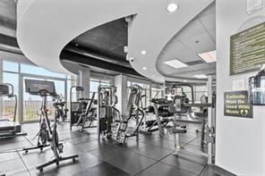 exercise room featuring a wall of windows and recessed lighting