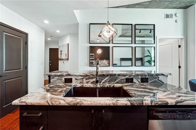 kitchen with visible vents, hanging light fixtures, light stone countertops, stainless steel dishwasher, and a sink