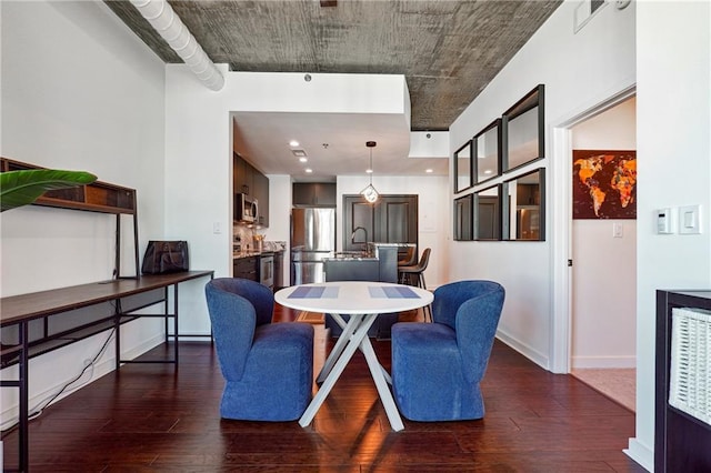 dining room with visible vents, hardwood / wood-style flooring, and baseboards