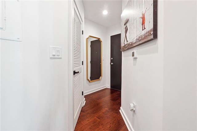 corridor featuring recessed lighting, dark wood-style flooring, and baseboards