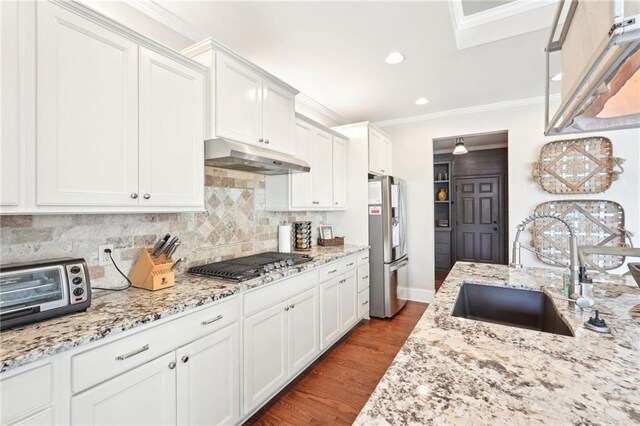 bedroom with ornamental molding, hardwood / wood-style floors, ceiling fan, and a raised ceiling