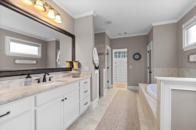 bathroom with crown molding, a healthy amount of sunlight, tiled tub, and vanity