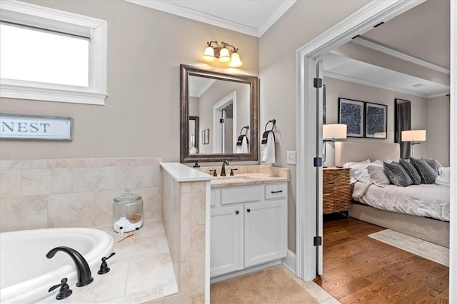 bathroom featuring vanity, hardwood / wood-style flooring, crown molding, and a relaxing tiled tub