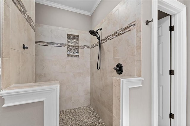 bathroom featuring tiled shower and ornamental molding