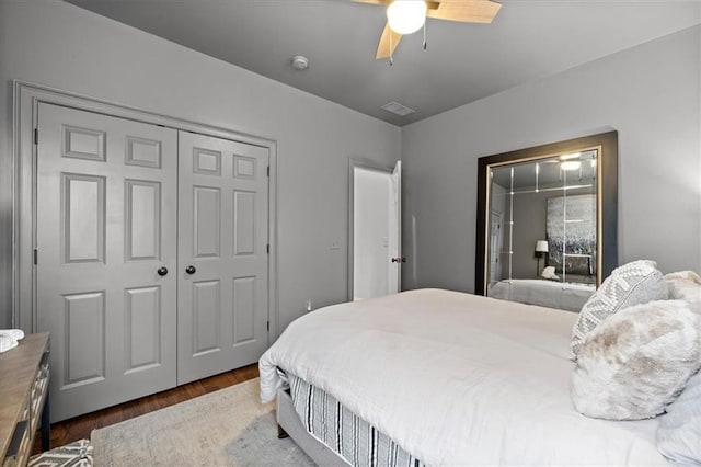 bedroom with wood-type flooring, a closet, and ceiling fan