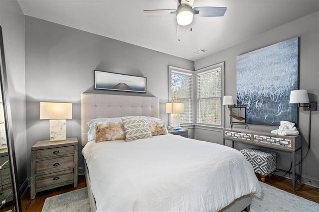 bedroom with ceiling fan and dark hardwood / wood-style floors