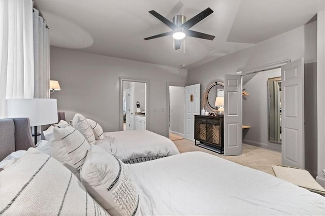 carpeted bedroom featuring ceiling fan and connected bathroom