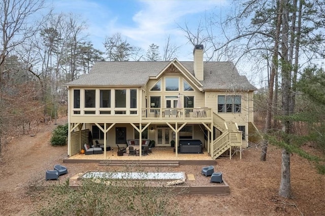 back of house featuring a sunroom, a hot tub, a patio, central air condition unit, and a deck