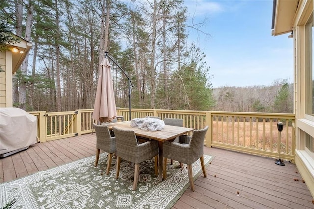 wooden terrace featuring a grill