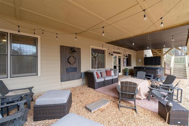 view of patio with an outdoor living space and a hot tub