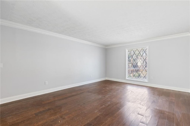 unfurnished room featuring a textured ceiling, dark wood-type flooring, baseboards, and ornamental molding