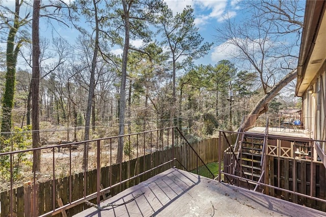 deck featuring stairway and a fenced backyard