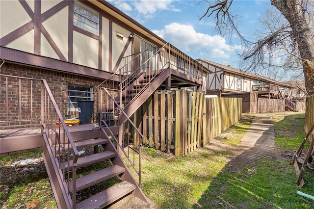 exterior space featuring stairway, a deck, and fence