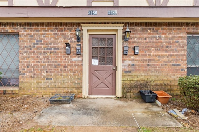 view of exterior entry with brick siding