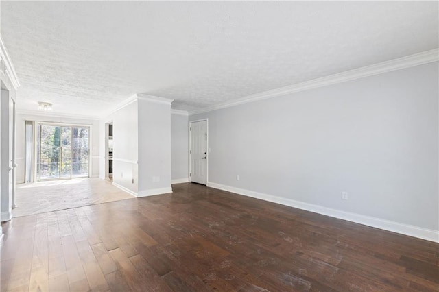 spare room with baseboards, a textured ceiling, wood finished floors, and crown molding