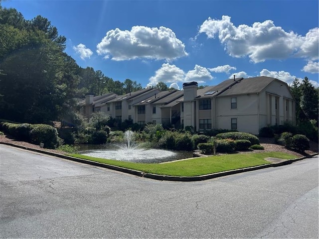 view of front of house with a water view