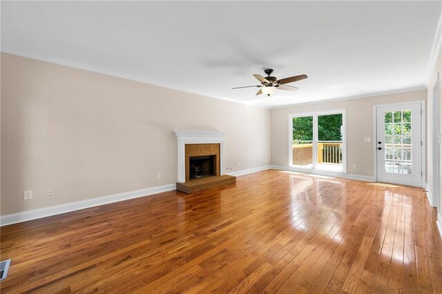 unfurnished living room featuring hardwood / wood-style flooring, ceiling fan, and ornamental molding