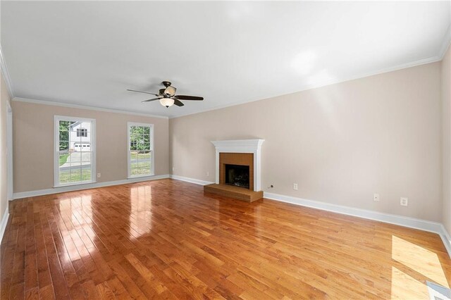 unfurnished living room with ceiling fan, light hardwood / wood-style floors, and ornamental molding