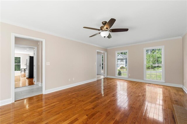 unfurnished room featuring ceiling fan, ornamental molding, and hardwood / wood-style flooring