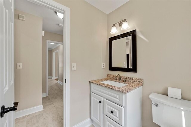 bathroom featuring vanity and toilet