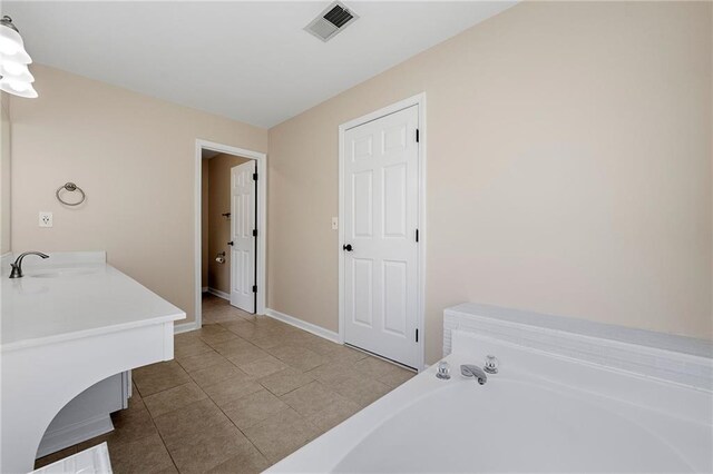 bathroom with vanity, tile patterned floors, and a bathing tub