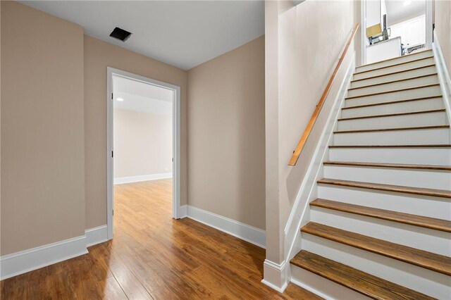 stairway featuring hardwood / wood-style flooring