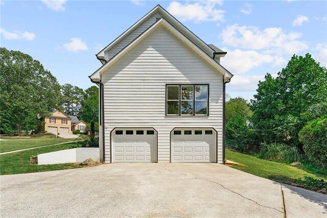 view of property exterior featuring a lawn and a garage