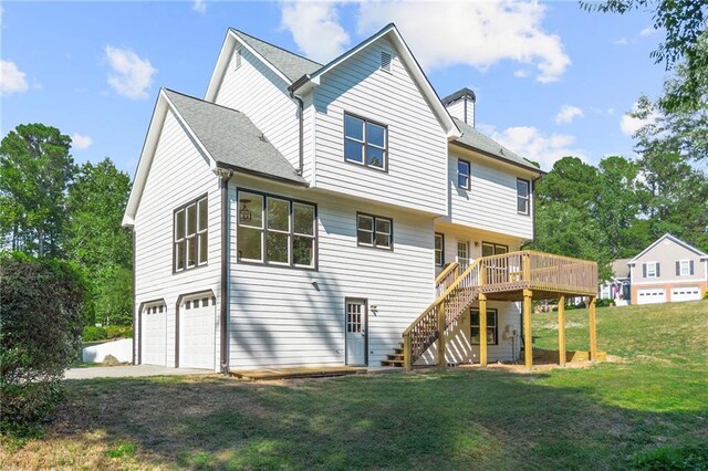 back of house featuring a wooden deck, a yard, and a garage