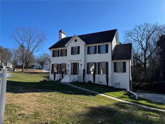 colonial home with a front yard