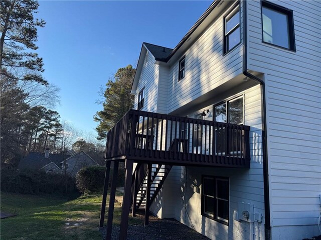 view of side of property featuring a wooden deck