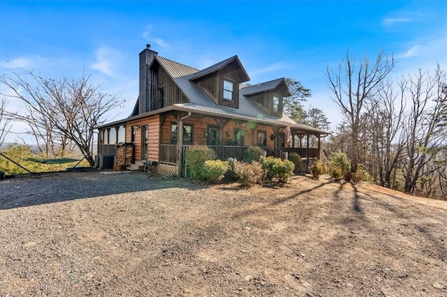 view of home's exterior with covered porch and central air condition unit