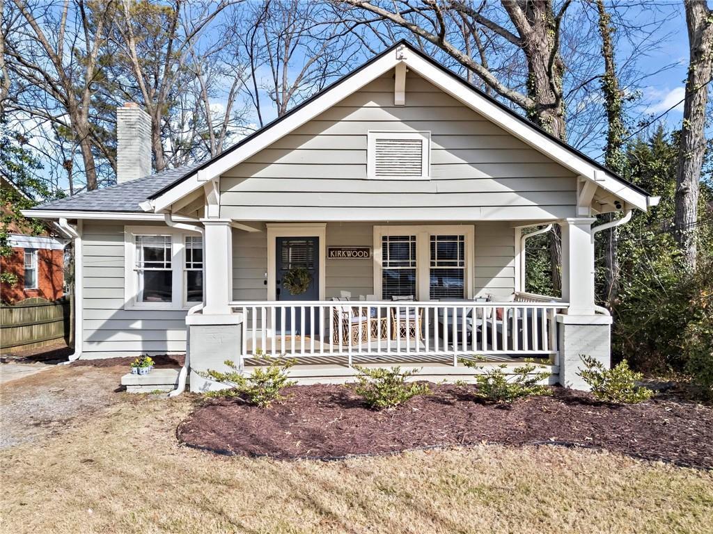 bungalow with a front yard and a porch