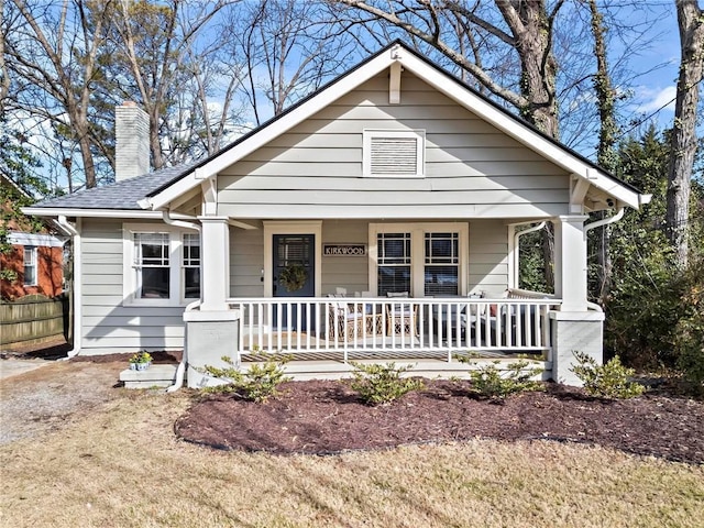 bungalow with a front yard and a porch