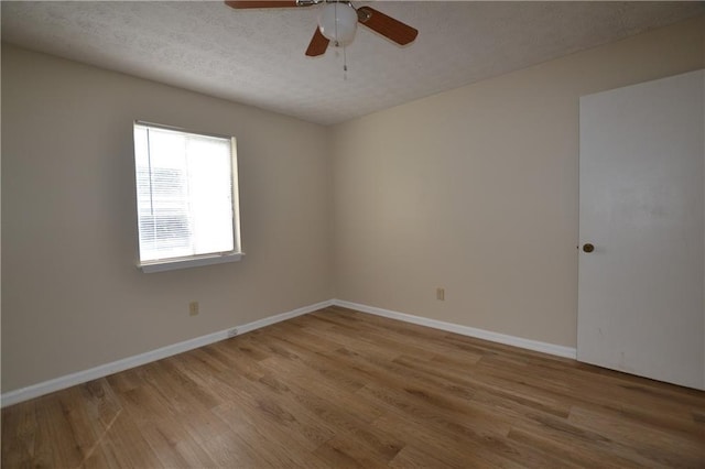 unfurnished room with ceiling fan, hardwood / wood-style floors, and a textured ceiling