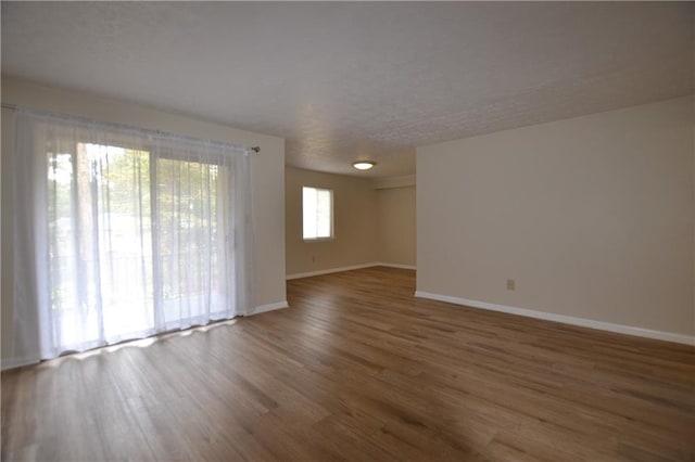 empty room with dark hardwood / wood-style flooring