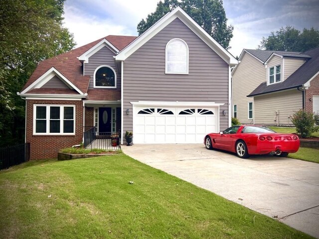 view of front of house featuring a front yard and a garage