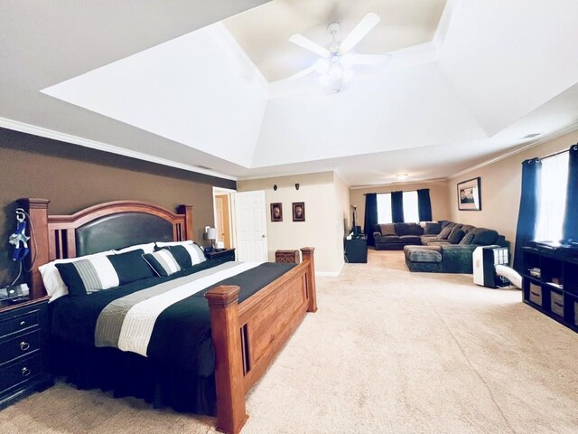 bedroom with carpet, ceiling fan, ornamental molding, and a tray ceiling