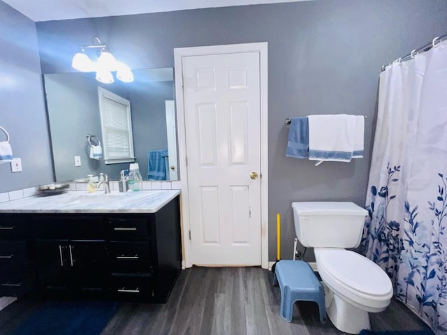 bathroom featuring vanity, toilet, and hardwood / wood-style flooring