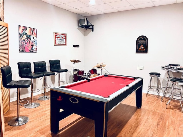 rec room featuring billiards, a paneled ceiling, and light hardwood / wood-style flooring