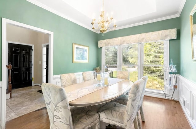 dining area with dark hardwood / wood-style floors, a chandelier, and crown molding