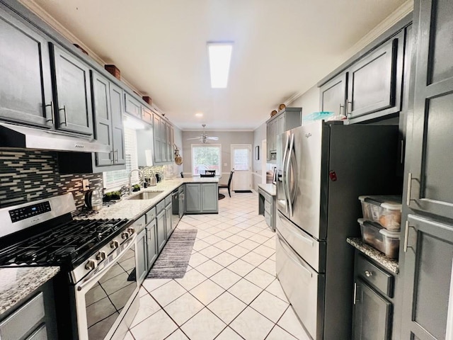 kitchen featuring gray cabinetry, light tile patterned floors, stainless steel appliances, sink, and ornamental molding