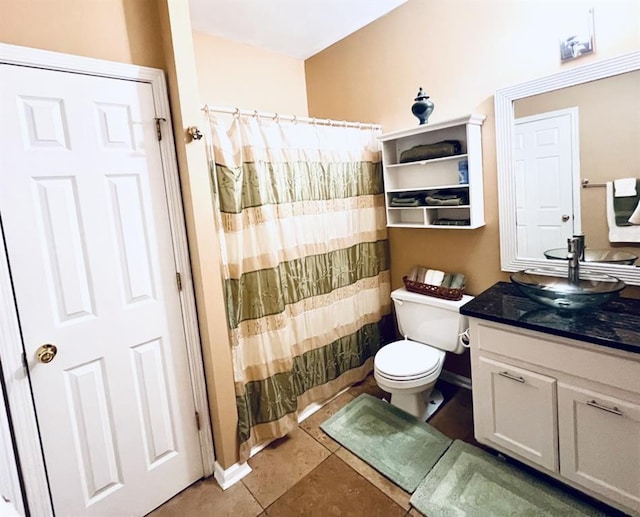 bathroom with a shower with curtain, tile patterned flooring, toilet, and vanity