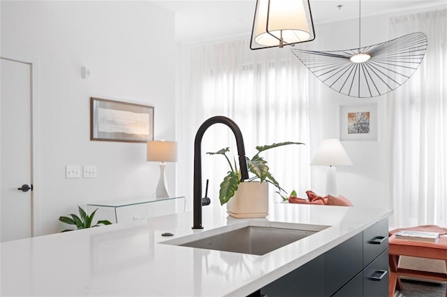 567 Ponce De Leon Ave NE Unit 614, Atlanta, GA 30308 - kitchen view of a sink, light countertops, dark cabinetry, modern cabinets, and pendant lighting