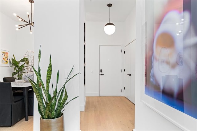 567 Ponce De Leon Ave NE Unit 614, Atlanta, GA 30308 - corridor with a chandelier and light wood-style flooring