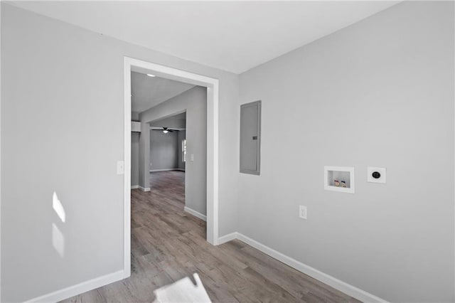 laundry area with hookup for a washing machine, electric dryer hookup, electric panel, and light wood-type flooring