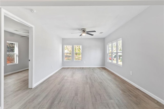 empty room with ceiling fan and light wood-type flooring