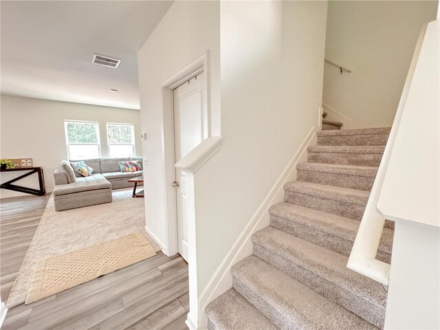 stairway with hardwood / wood-style floors