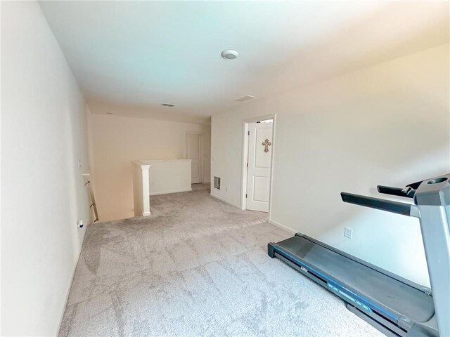 exercise room with light colored carpet